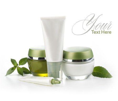 Jars of cream with green leaves isolated on whiteの写真素材