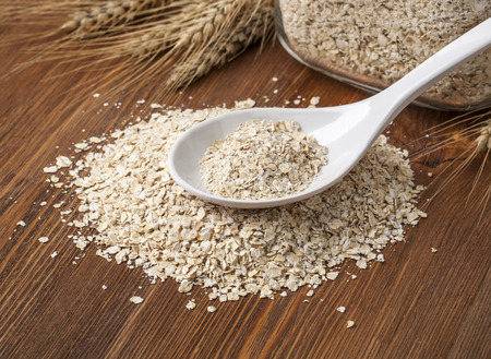 Oat flakes. Selective focus. on wooden table