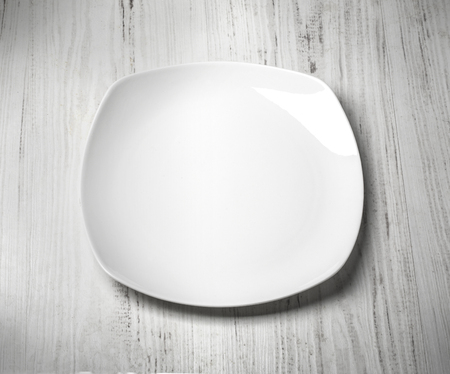 white plate on wooden background close upの写真素材