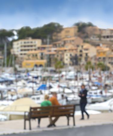 abstract background blur people, unrecognizable silhouettes of tourists on the streets of the port resort townの写真素材