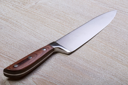 Knife on rustic kitchen table with copy space