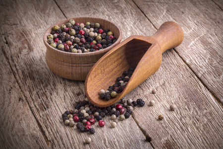 Black pepper corns  on wooden backgroundの写真素材
