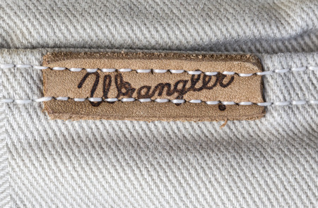 Chisinau, Moldova - August 19, 2016: Closeup of Wrangler label on white jeans. Wrangler is American manufacturer of jeans. Its headquarters is in Greensboro, North Carolina, USA.のeditorial素材