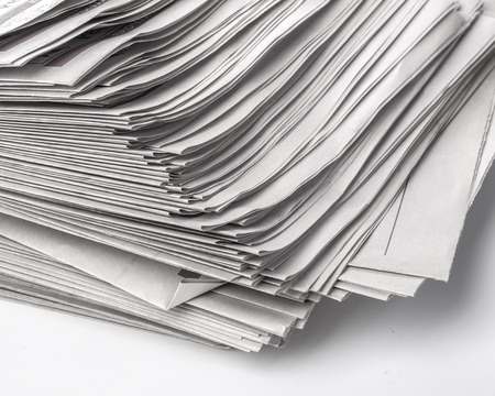 Pile of old newspapers close up background