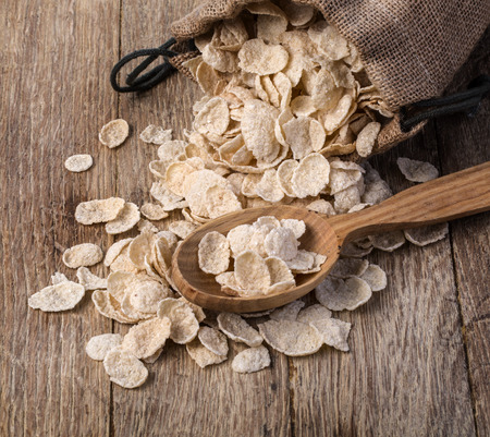 Oat cereal in burlap sack on wooden surface, top, view.の写真素材