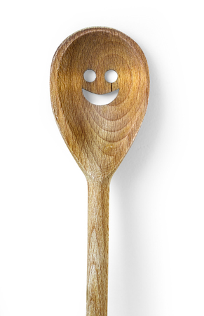 Wooden spoons with smile motif on white background. Wooden kitchen spoon With clipping pathの写真素材