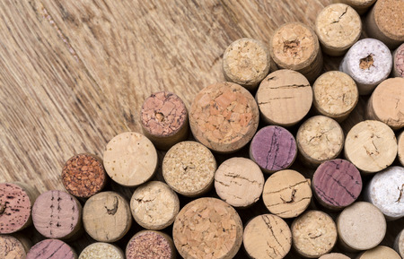 Wine corks over rustic wooden table background. Top view with copy spaceの写真素材