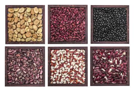 Multicolored beans in wooden  bowl isolated on whiteの写真素材