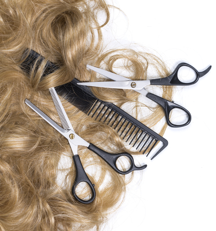 Hairdressing scissors with blonde hair. Isolated backgroundの写真素材
