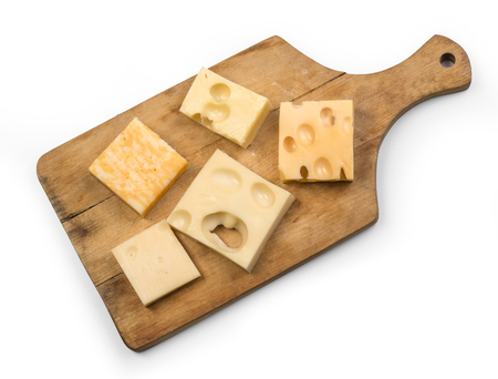 various types of cheese on wooden board isolated with clipping pathの写真素材