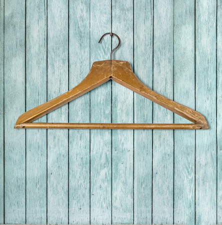 Clothing hanger on wooden  wall backgroundの写真素材
