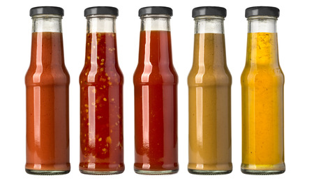 the various barbecue sauces in glass bottlesの写真素材