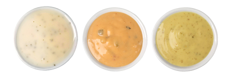 Close up Aerial Shot of Assorted Spicy Sauces on Saucers, Isolated on White.の写真素材