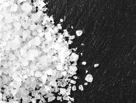 white salt on black background with copy spaceの写真素材