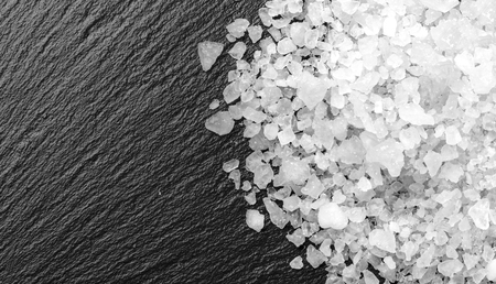 white salt on black background with copy spaceの写真素材