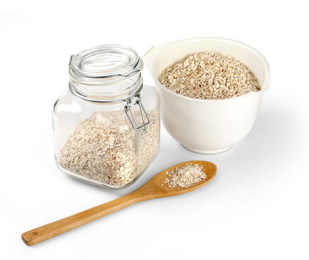 Glass jar with oatmeal flakes isolated on white backgroundの写真素材