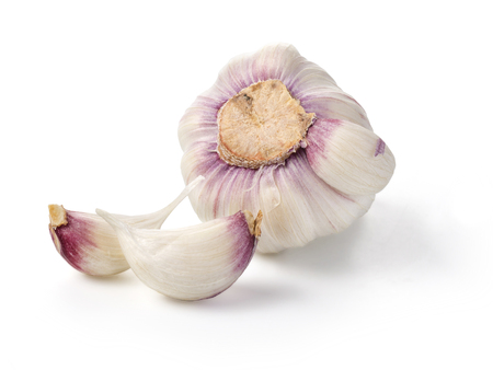 uncooked whole garlic with shell on white backgroundの写真素材