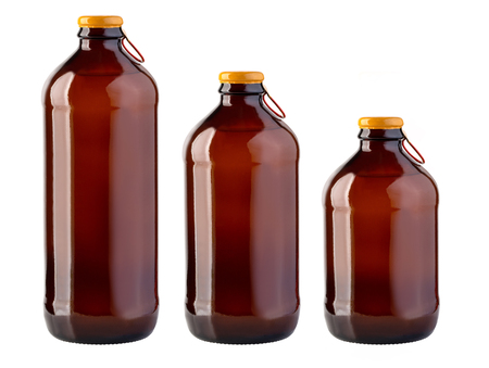 Brown glass beer bottle with yellow cap on white backgroundの写真素材