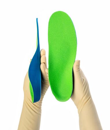 Female orthopedist with insole on white background, closeupの写真素材