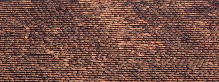 Old and ruined roofs. Texture of a roof with old roof tiles.の写真素材