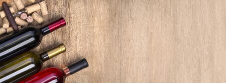 wine bottle, glass and  corks on wooden table background with copy spaceの写真素材