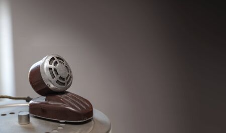 Retro microphone on table sepia photo with copy space