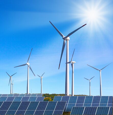solar panels with wind turbines  against blue sky の写真素材