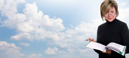 Smiling woman student, teacher or business lady holding books. Isolated studio portrait of business person.の写真素材