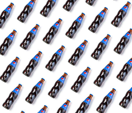 Chisinau, Moldova - April 26, 2020:    Pepsi glass bottle lying on white background. Texture. Top view Pepsi is a carbonated soft drink that is produced and manufactured by PepsiCoのeditorial素材