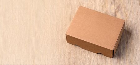 Empty brown carton box on the wooden table