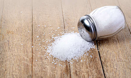 An old wooden table with a salt shaker