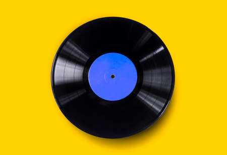 Vinyl record on a colored background. Old vintage vinyl record isolatedの写真素材