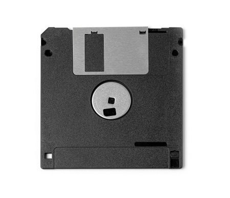 Old computer and data storage technology, black plastic magnetic floppy disk 3Â½ inches, isolated...