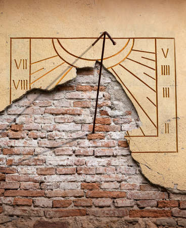 Old stone sundial close up with roman numeralの写真素材