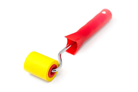 Yellow rubber paint roller on a white background.