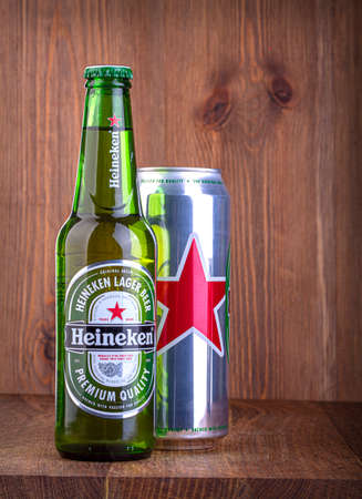 Chisinau, Moldova - February 05, 2016 Beer Heineken bottle and metal can, on wooden background, with copy spaceのeditorial素材
