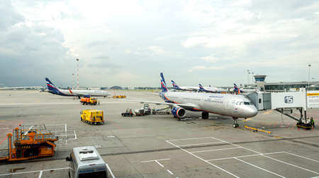 Moscow, Russia - July 13, 2017: Servicing passenger airplane with airbridge before boarding. Departure from Sheremetyevo International. Airport Sheremetyevo-modern aircraft is awaiting departureのeditorial素材