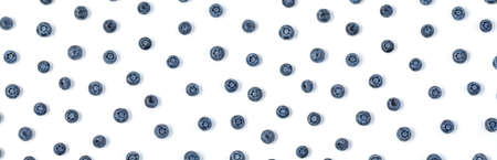 A colorful of blueberries is wide-format on a white background. Top view Fresh blueberries layout...