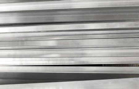 Steel rolled metal products. Stack of square, steel rods