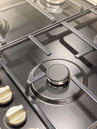 black metal kitchen stove close up in home kitchen. background gas crisis