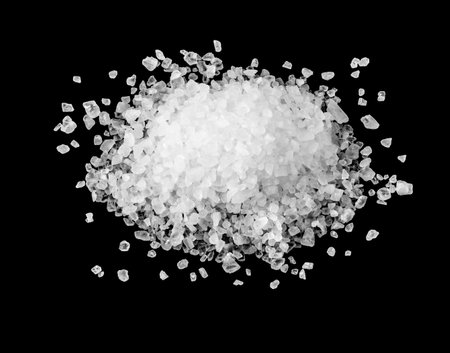 A heap of sea salt on black background.