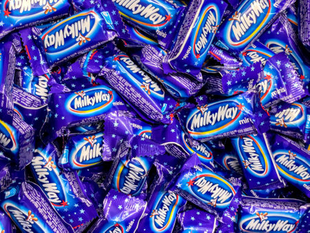 Anapa, Russian Federation - 07 December, 2022: Milky Way wrapper isolated on white. Twix is a chocolate bar made by Mars, Inc., consisting of biscuit applied with caramel and milk chocolate.のeditorial素材