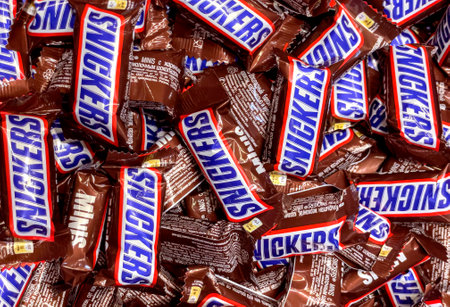 Anapa, Russian Federation - 07 December, 2022: snickers wrapper isolated on white. Twix is a chocolate bar made by Mars, Inc., consisting of biscuit applied with caramel and milk chocolate.のeditorial素材