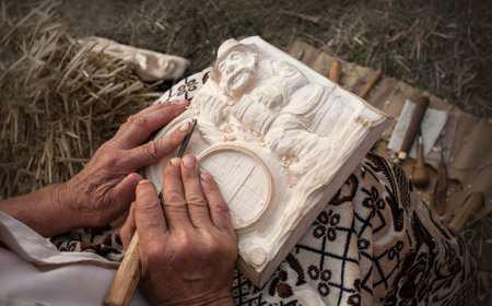 Popular artisan carving in wood in his atelier. Moldavian  folk art.の写真素材