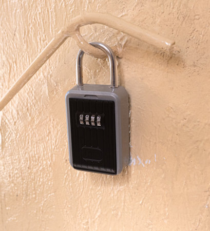 A smart lock with a key installed near the door for renting out an apartment. The key safe is used...