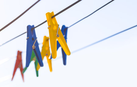 Colorful clothespins on the hangers. Plastic clothespins in different colors. with copy space