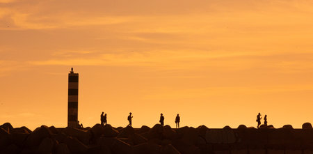 Silhouettes of people on the view point in the rays of the sun during the golden hour.