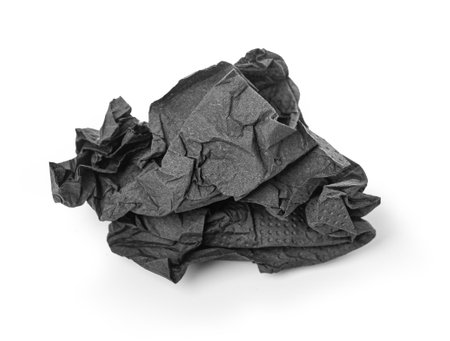 Crumpled black paper napkin - unused, isolated on whiteの写真素材