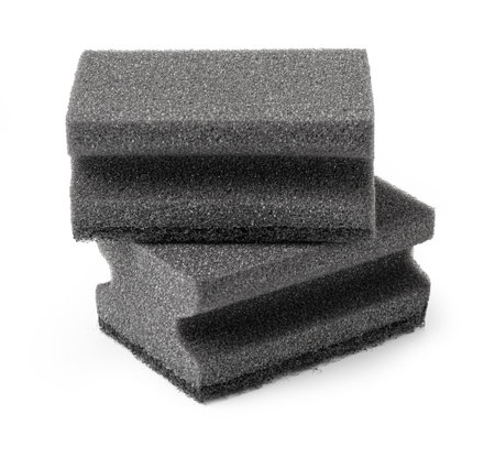 Black sponge used for washing dishes and art projects. Isolated on white.の写真素材