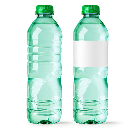 Two small green water bottles isolated on white background, one with blank white label and one without labelの写真素材